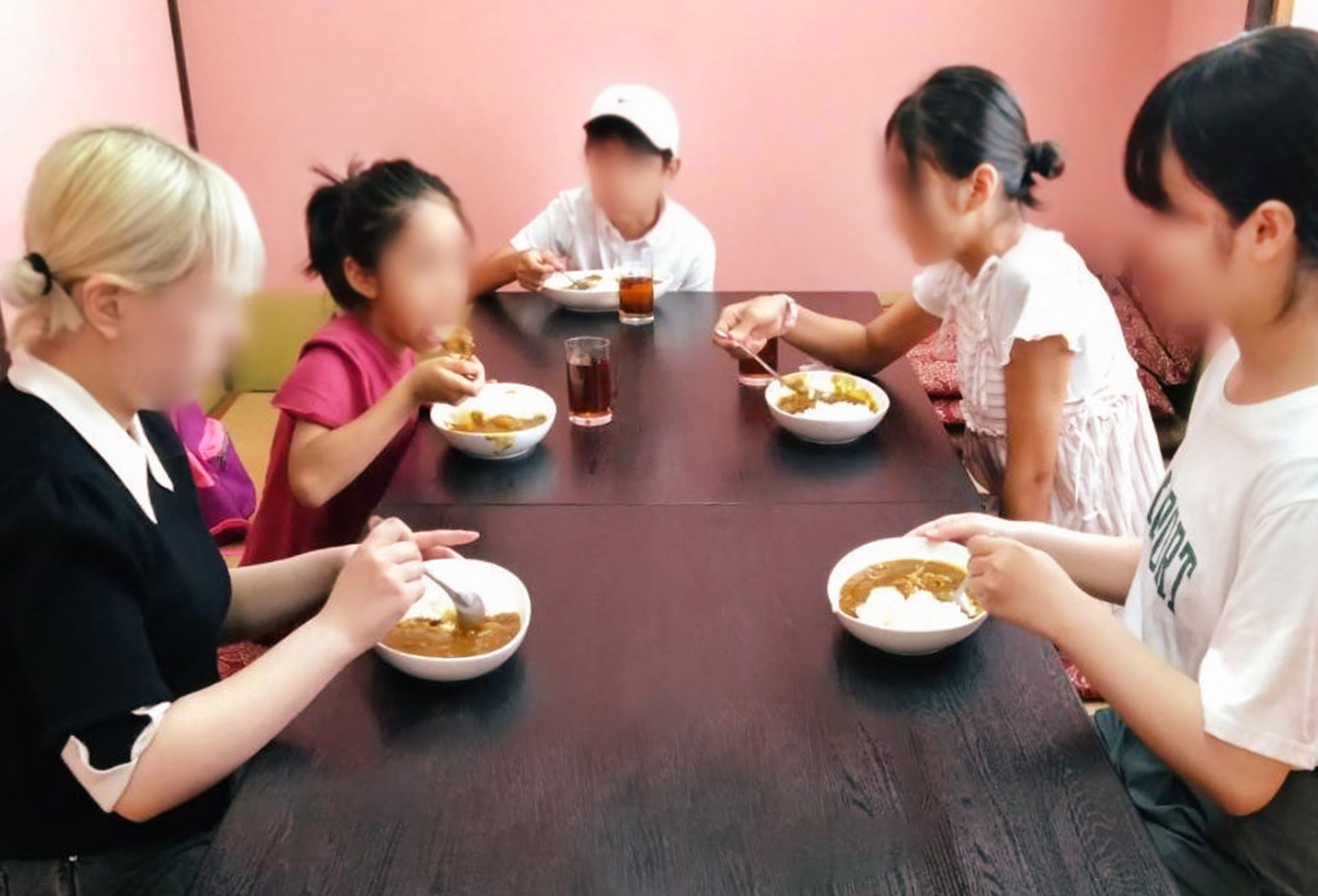 Children enjoying the Boss's special curry.